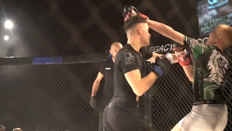 Two fighters trading strikes in the cage on a fight night, a referee watching